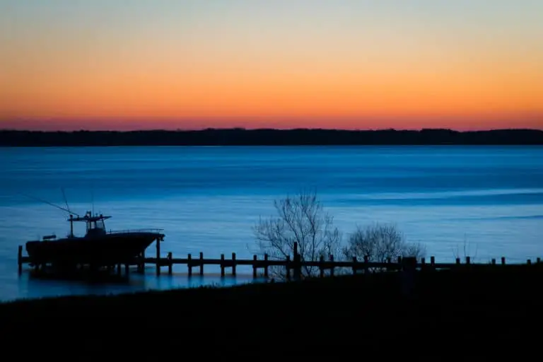 A beautiful sunset and boat on the Rappahannock River - great views to enjoy while taking part in all of the great things to do in Irvington, VA